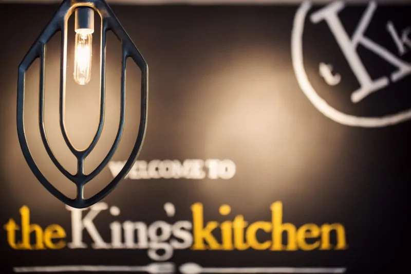 The Ultimate Weekend in Charlotte NC featured by top travel blog, The Common Traveler: Charlotte sign with Welcome to the King's Kitchen with light in front