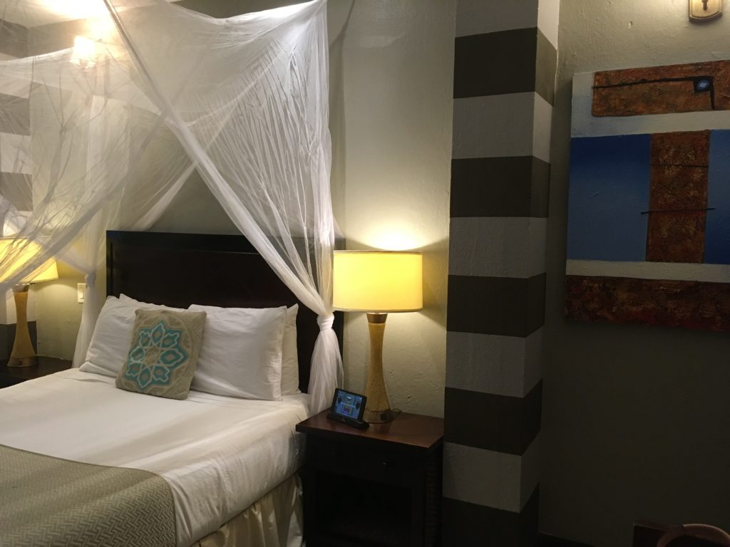hotel in Old San Juan bed with netting above it and striped column in Casablanca Hotel, San Juan