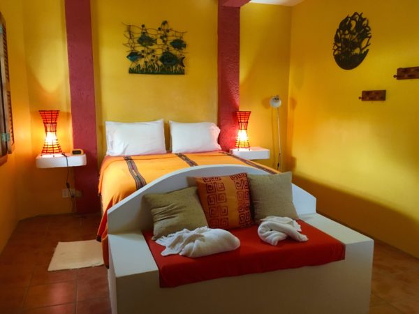 bed with red, orange, and yellow - tropical