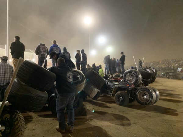 pit crews watching the World of Outlaws races at night