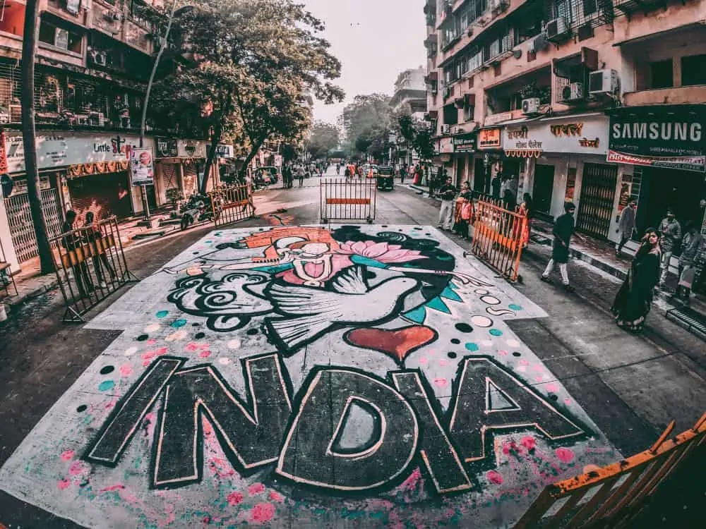 One month India itinerary featured by top travel blog, The Common Traveler. Image - India sidewalk art on street.