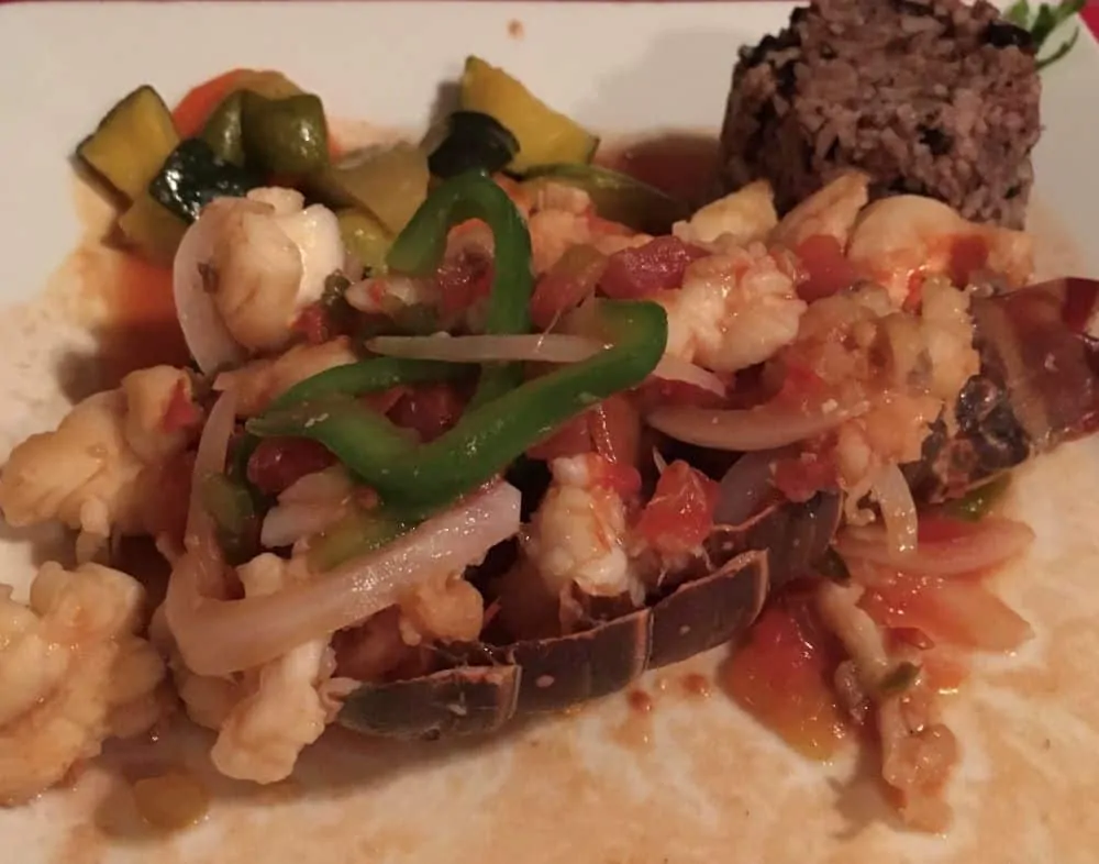 The Best Restaurants in San Pedro Belize featured by top travel blog, The Common Traveler; Photo of stuffed lobster tail at El Fogon