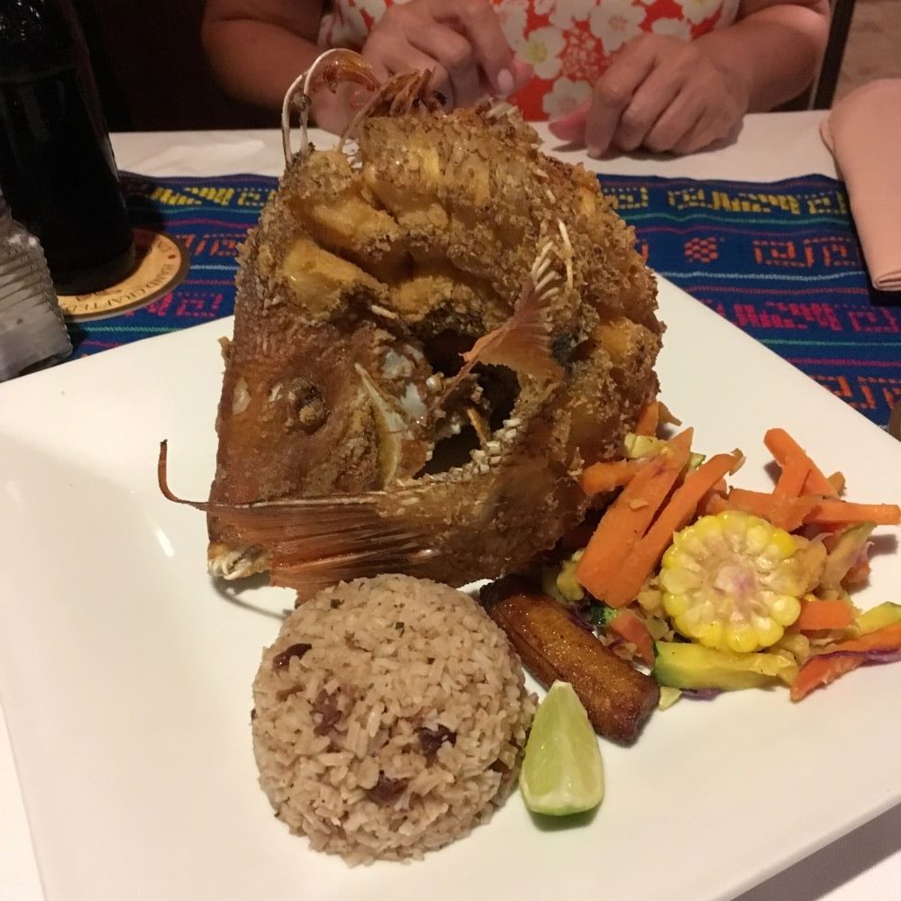 The Best Restaurants in San Pedro Belize featured by top travel blog, The Common Traveler; Photo of fried fish plate at Elvi's Kitchen