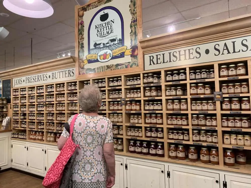 woman in front of jarred foods from Kitchen Kettle Village in PA Dutch country