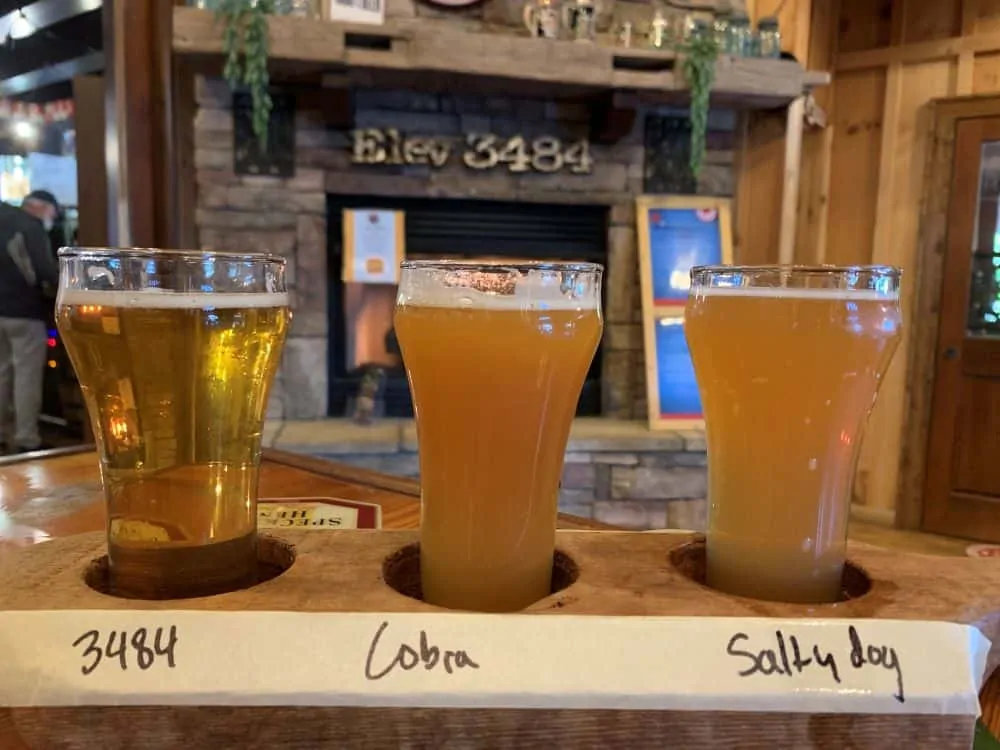flight of 3 beers in front of fireplace at Whiteside Brewing, Cashiers, NC