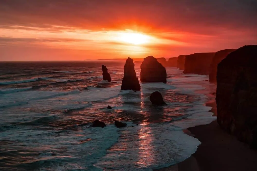 5 Top Tips for a road trip in a campervan in Australia featured by top travel blogger, The Common Traveler: Apostles in Australia at sunset