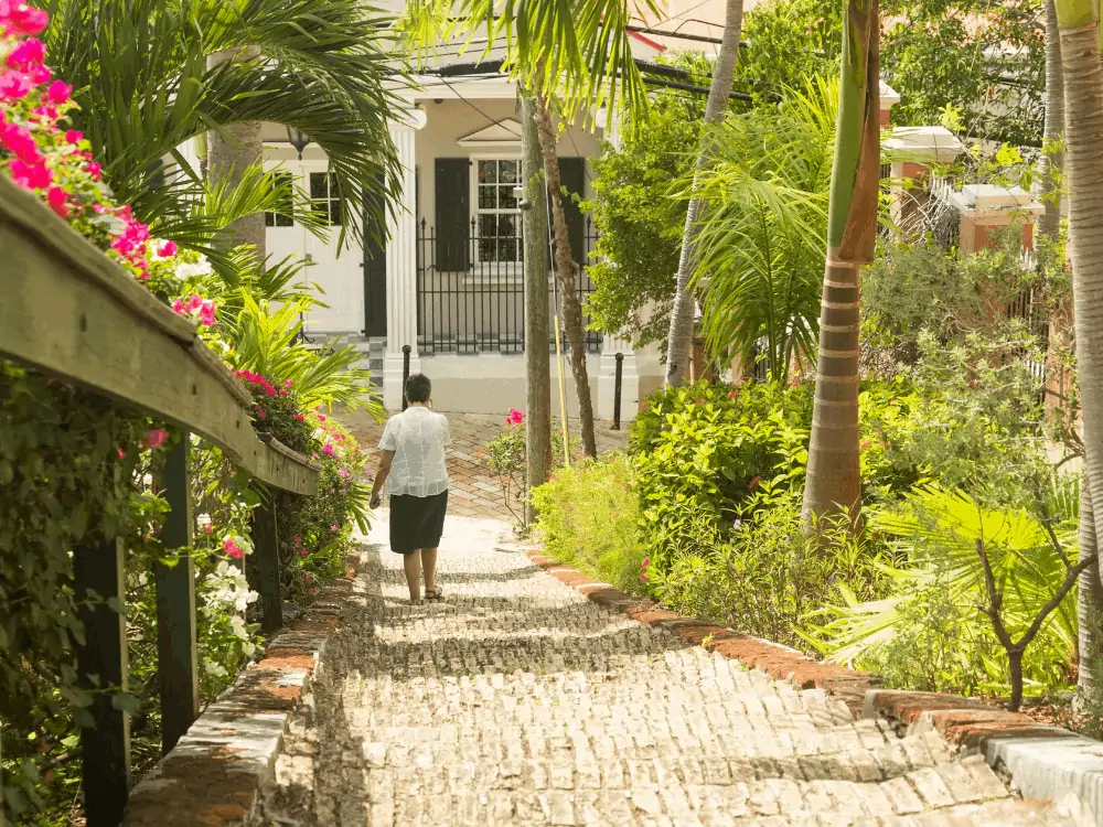 Image: woman walking down brick 99 brick steps in St. Thomas USVI | Best Things to do in the US Virgin Islands: image of a woman walking down the 99 steps in St. Thomas. 