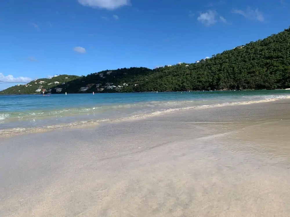 Image: white sand beach with mountain in background, Magens Bay, St. Thomas, USVI |Best Things to do in the US Virgin Islands: image of Magens Bay. 