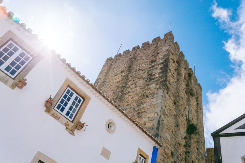 image: historic tower in Obidos, Portugal |Things to do in Portugal by popular US international blog, The Common Traveler: image of a historic stone tower in Obidos Portugal. 