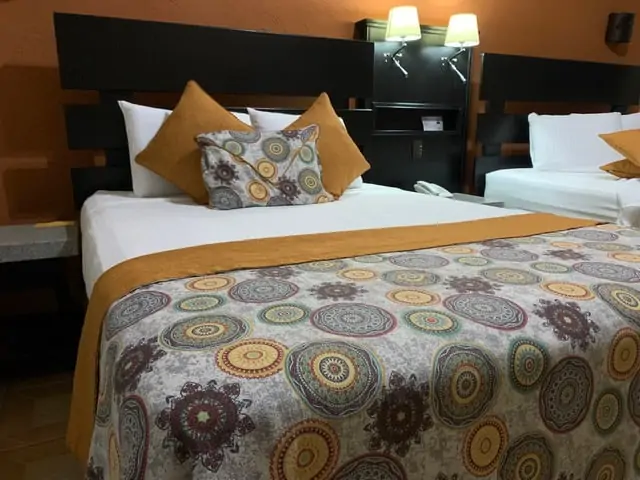 Arenal Springs Resort review featured by top international travel blogger, The Common Traveler | image: beds with pillows at resort