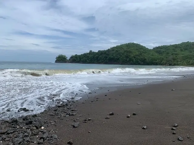Hotel Punta Islita | The Common Traveler | image: black sand beach Punta Islita in Costa Rica | Hotel Punta Islita by popular US international travel blog: image of a black sand beach in Costa Rica.
