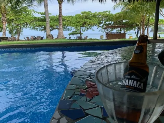 Hotel Punta Islita | The Common Traveler | image: swim up bar with beach in background | Hotel Punta Islita by popular US international travel blog: image of a swim up bar at Hotel Punta Islita.