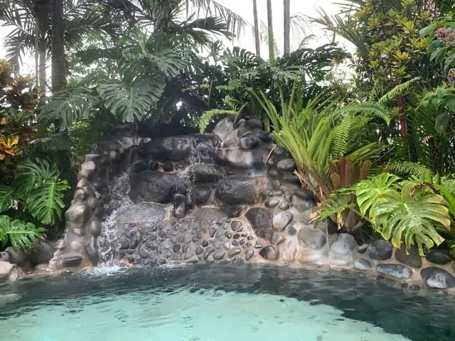 Arenal Springs Resort review featured by top international travel blogger, The Common Traveler | image: springs over rock in pool