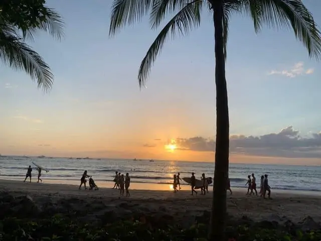 A Complete 10 Day Costa Rica Itinerary | The Common Traveler | image: people walking on Tamarindo Beach at sunset | Costa Rica Itinerary by popular US international travel blog, The Common Traveler: image of people walking on Tamarindo Beach during a sunset.