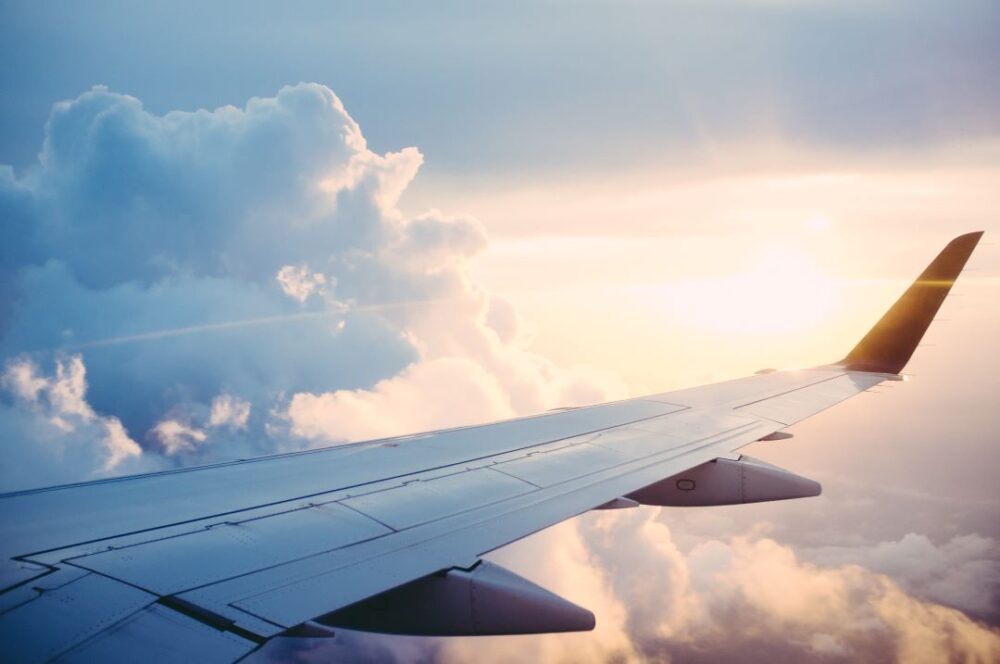 9 LESSONS LEARNED WHILE TRAVELING DURING A PANDEMIC featured by top international travel blogger, The Common Traveler \ image: airplane wing with clouds