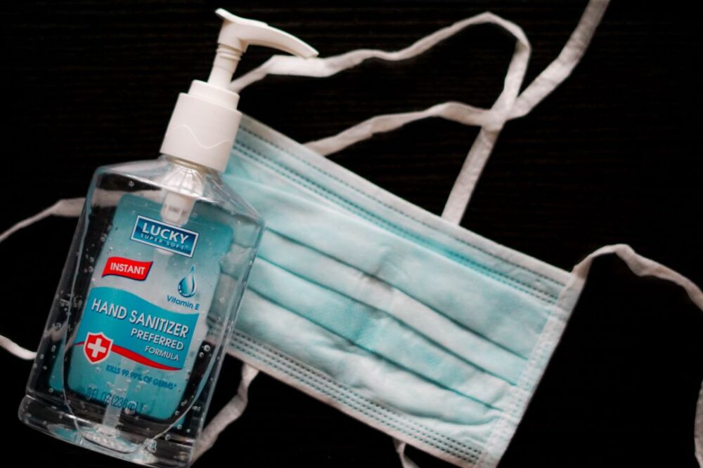 9 LESSONS LEARNED WHILE TRAVELING DURING A PANDEMIC featured by top international travel blogger, The Common Traveler | image: face mask and hand sanitizer bottle