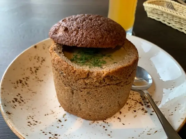 20 Lithuanian Food and Drinks to Try featured by The Common Traveler | image: mushroom soup in bread bowl