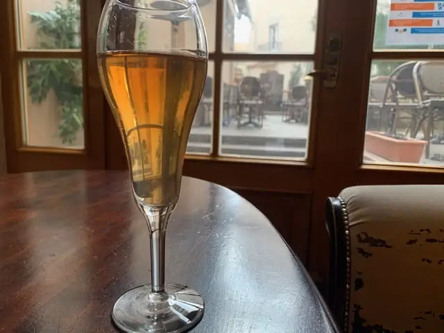 20 Lithuanian Food and Drinks to Try featured by The Common Traveler | image: glass of wine on table