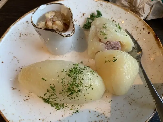 20 Lithuanian Food and Drinks to Try featured by The Common Traveler | image: potato dumplings