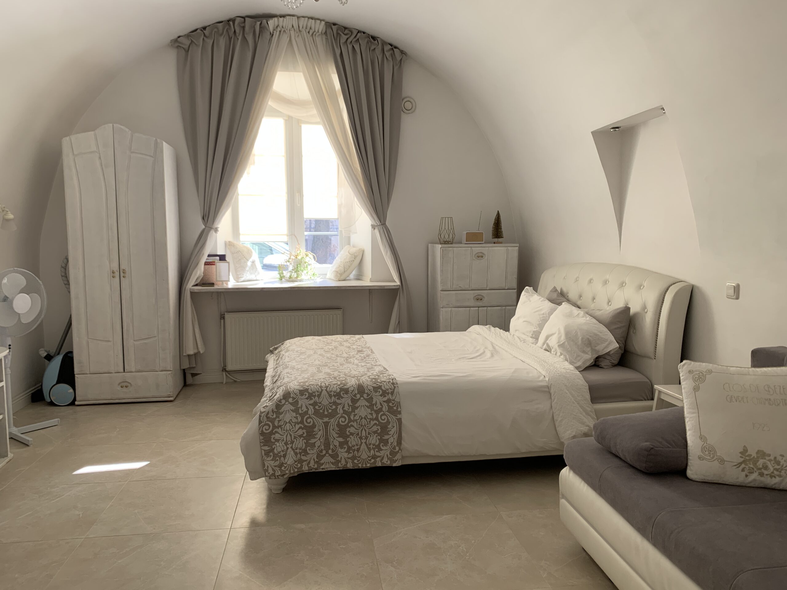 Queen bed in white room at Airbnb in Vilnius, Lithuania