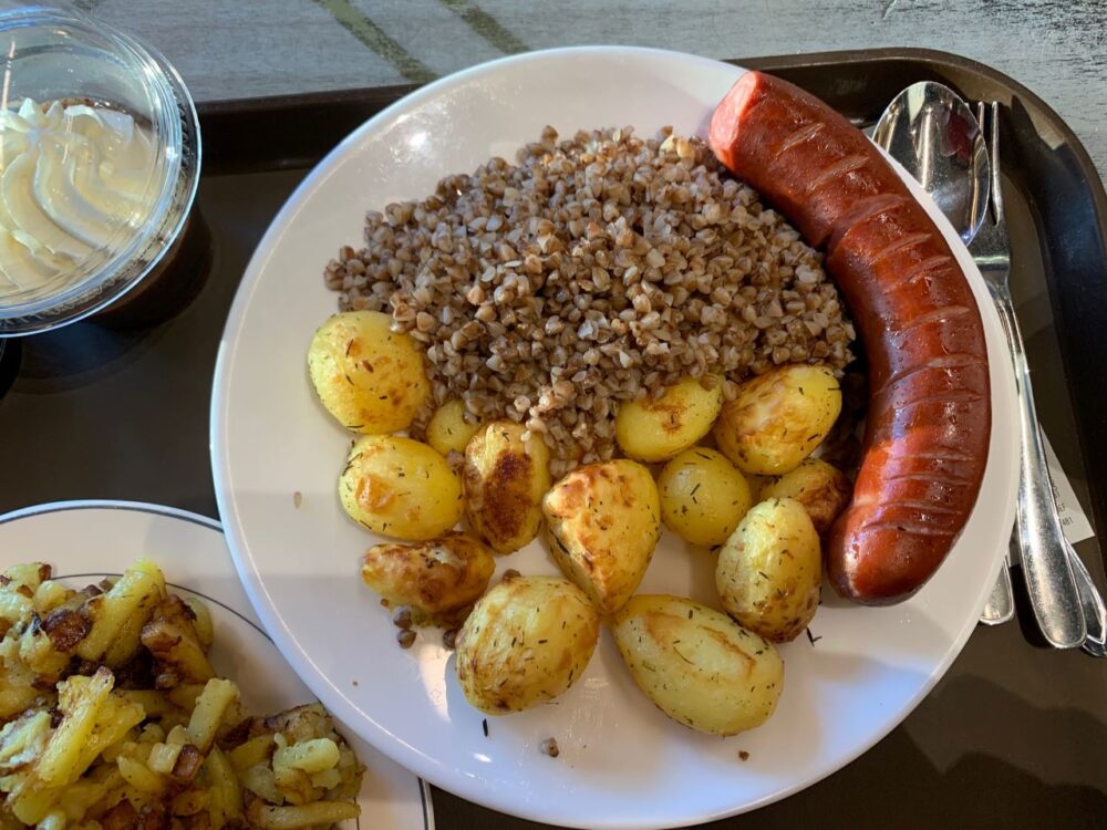 plate with fried potatoes, buckwheat, and sausage from Lido in Riga