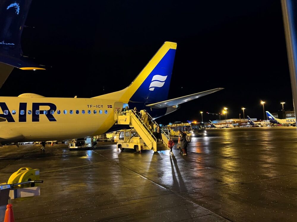 Know Before Visiting Iceland in Winter | The Common Traveler | image: airplane on tarmac with ladder with passengers disembarking