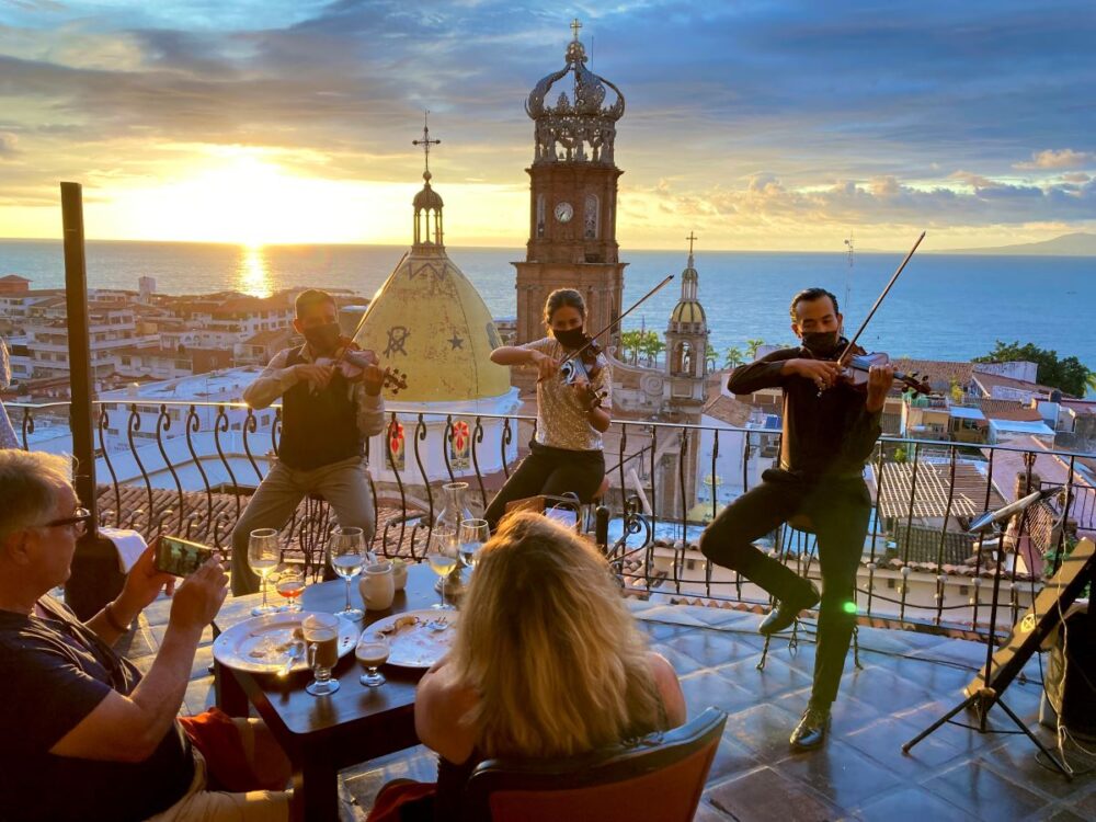 4 Days in Puerto Vallarta | The Common Traveler | image: violinists at La Capella with Puerto Vallarta church in background at sunset