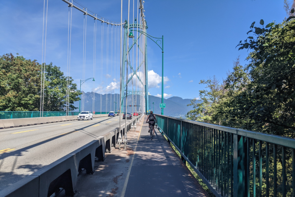 21 Best Things to Do in Vancouver | The Common Traveler | image: cyclist on Lyons Bridge at Stanley Park