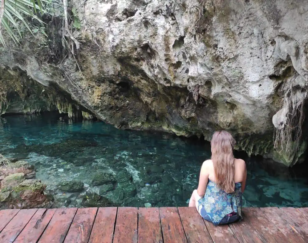 Complete Guide to Tulum on a Budget | The Common Traveler | image: woman on boardwalk at Gran Cenote