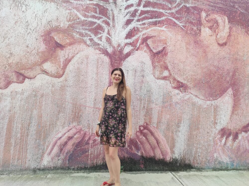 Complete Guide to Tulum on a Budget | The Common Traveler | image: woman in front of mural in Tulum