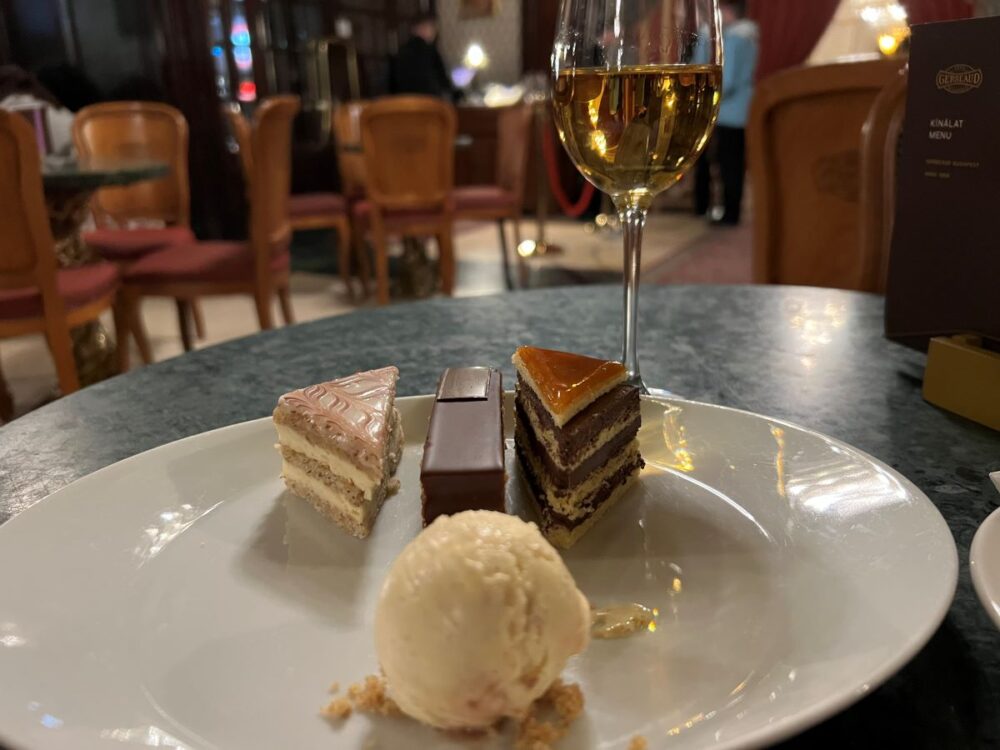 Hungarian Foods and Drinks to Try | The Common Traveler | image: plate with ice cream, three slices of cake, and glass of tokaji