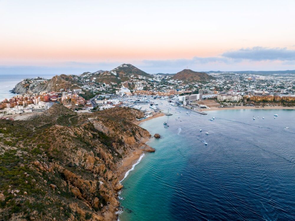 Cabo vs Cancun: Where Should You Go? | The Common Traveler | image: bay with hills in Cabo