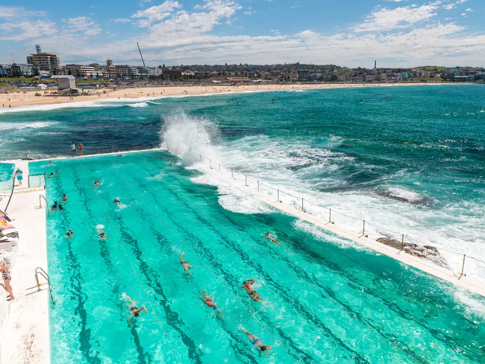 5 Amazing Beaches to Visit in Australia | The Common Traveler | image: swimmers in pool at Bondi Beach, Sydney