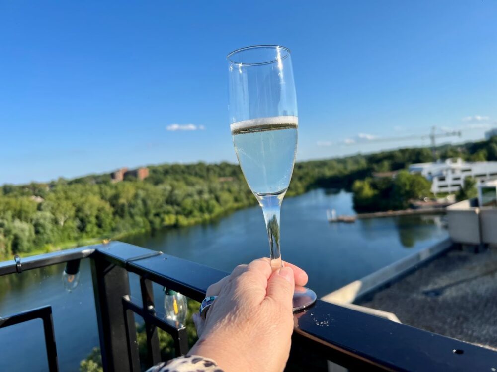Howard County MD Weekend Adventure | The Common Traveler | image: champagne glass with Lake Kittamaqundi in background