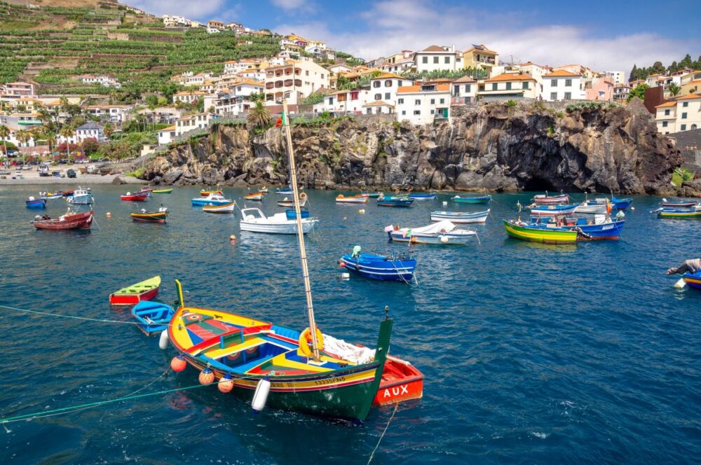 Europe on a Budget | The Common Traveler | image: colorful boats in Madeira, Portugal