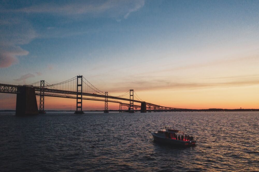 20 Things to Do on Kent Island, Queen Anne's County, MD | The Common Traveler | image: boat at sunset with Chesapeake Bay Bridge