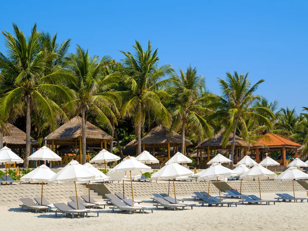 Is Nha Trang Worth Visiting? | The Common Traveler | image: chairs and umbrellas on Doc Let Beach