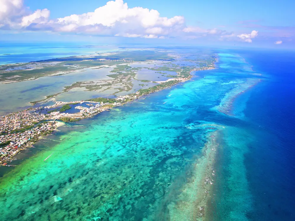 Caye Caulker or Ambergris Caye? | The Common Traveler | image: aerial view of Ambergris Caye
