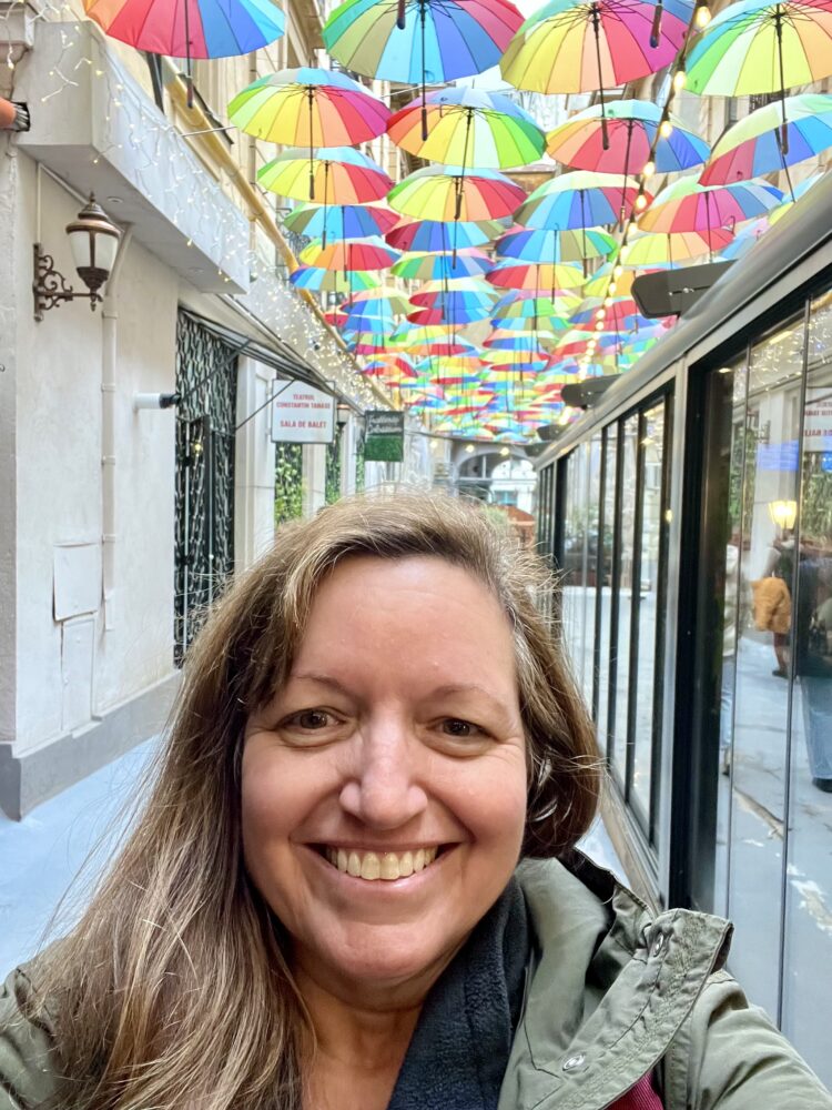 Things to Do in Bucharest | The Common Traveler | image: woman in umbrella street