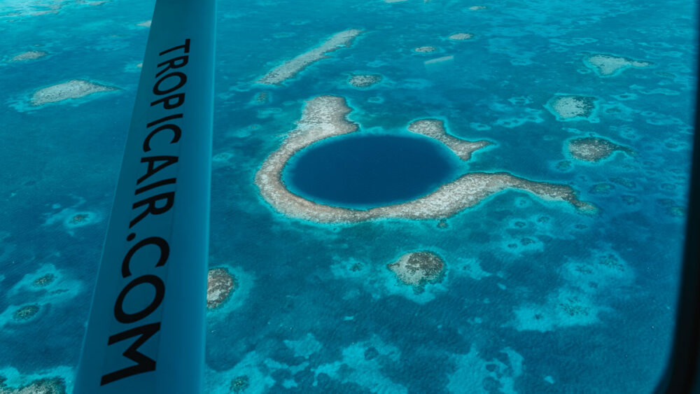 Caye Caulker or Ambergris Caye? | The Common Traveler | image: aerial view of Blue Hole in Belize