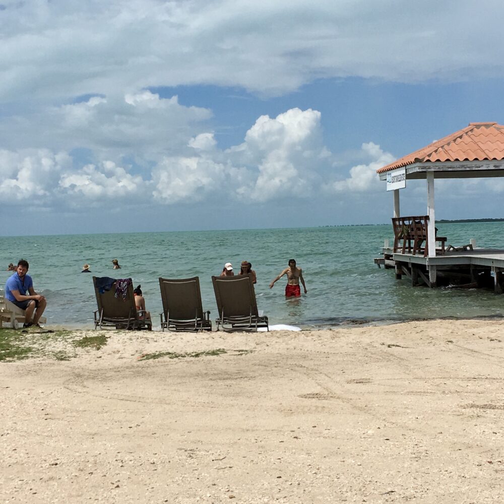 Caye Caulker or Ambergris Caye? | The Common Traveler | image: chairs and people at Secret Beach in San Pedro