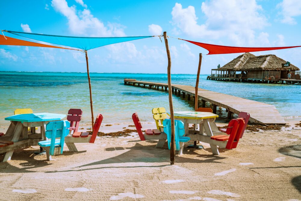 Caye Caulker or Ambergris Caye? | The Common Traveler | image: colorful chairs and deck in Belize