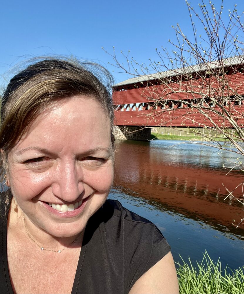 Insta-Worthy Photo Spots in Gettysburg and Adams County | The Common Traveler | image: woman with red Sachs Covered Bridge in background