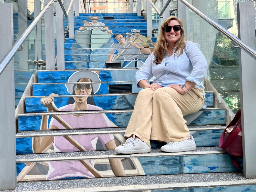 SE Asia Cruise: Packing Tips and List | The Common Traveler | image: woman on stair mural in Hong Kong