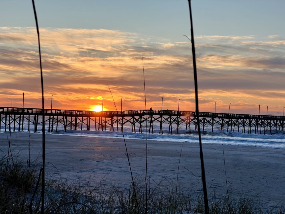 Best NC Beaches to Find Shark Teeth | The Common Traveler | image: sunrise at pier on Topsail Island
