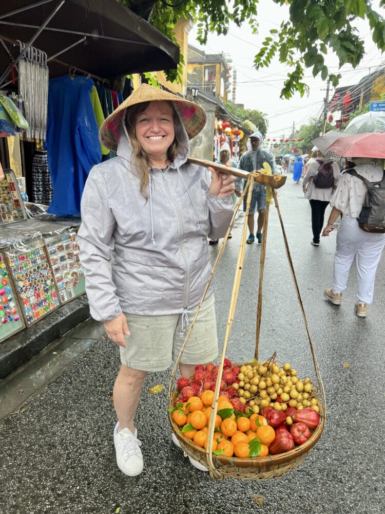 SE Asia Cruise: Packing Tips and List | The Common Traveler | image: woman in Vietnam carrying fruits 
