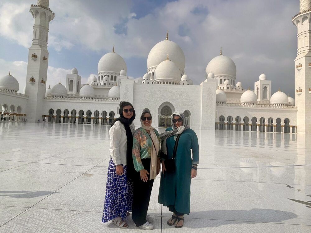 Middle East Packing List for Women | The Common Traveler | image: 3 women in sunglasses and scarfs at Sheikh Zayed Grand Mosque