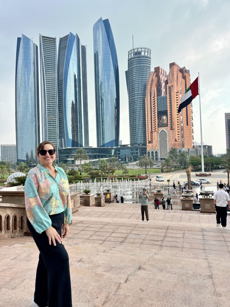 Middle East Packing List for Women | The Common Traveler | image: woman in black pants, map shirt in Abu Dhabi