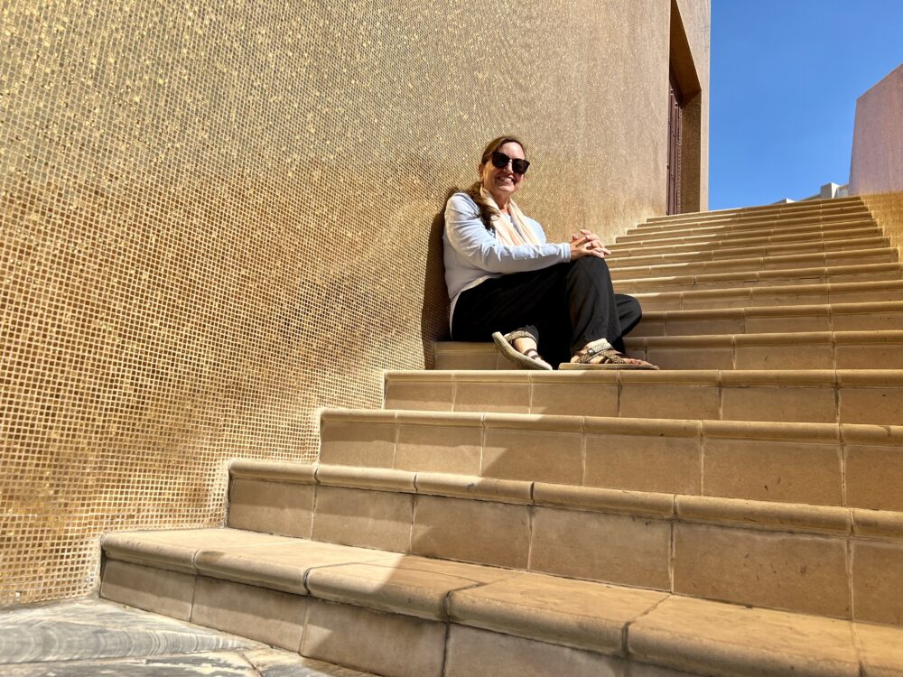 Slower Way To Experience Cities | The Common Traveler | image: woman sitting on steps in Doha