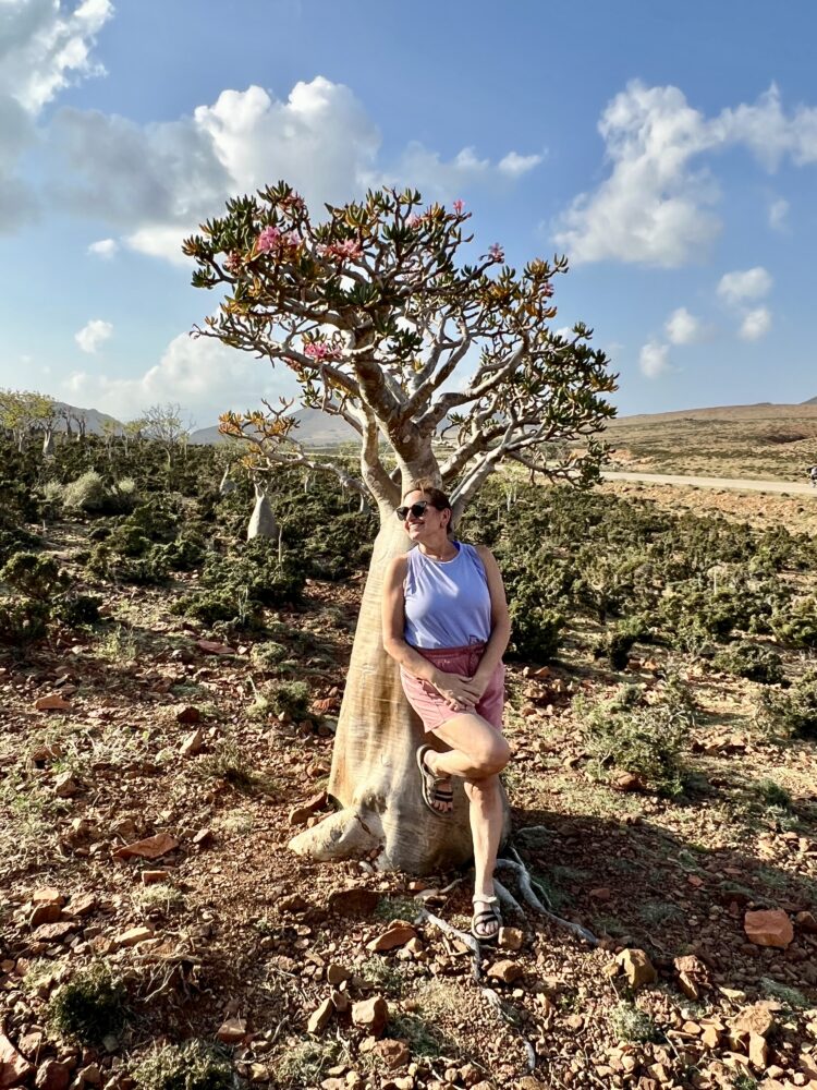 Middle East Packing List for Women | The Common Traveler | image: woman in pink shorts and lavender tank with bottle tree